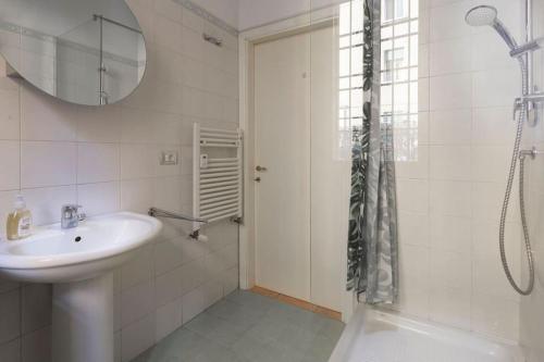 a white bathroom with a sink and a shower at Blu Flat in Bologna