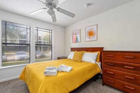 a bedroom with a bed with two towels on it at Spacious home 4BR in Tampa
