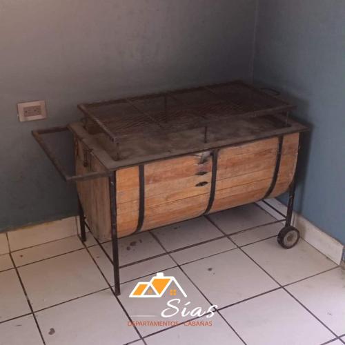 a wooden cabinet sitting on a tiled floor at Departamentos - Cabañas Sias in Creel
