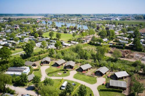 an aerial view of a village with a river at Glamping Betuwestrand in Beesd