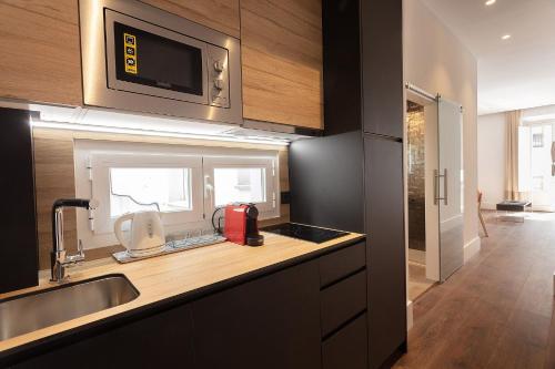 a kitchen with a sink and a counter top at Casa Miravalle Catedral in Granada