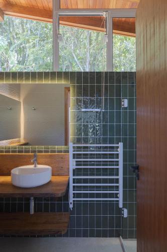 a bathroom with a sink and a mirror at Villa Serena Eco-Lodges in Garopaba