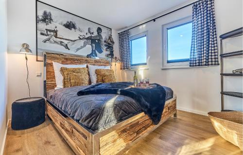 a bedroom with a large wooden bed and two windows at Chalet Bellevue in Winterberg