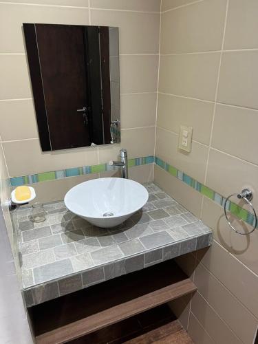 a bathroom with a sink and a mirror at Casa de Ushuaia in Ushuaia