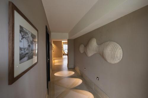 a hallway with a sculpture of a shell on the wall at Camp David Ranch in Santiago de los Caballeros