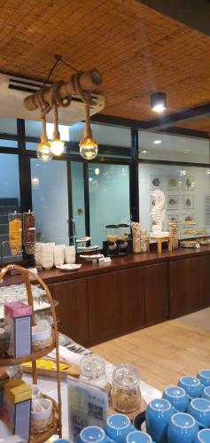 a store with blue dishes on display in a room at The Beach Resort & Residence - SHA Plus in Pathiu