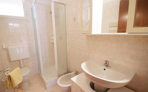 a bathroom with a sink and a toilet and a shower at Residence Rex Lo Scoglietto in Punta Ala