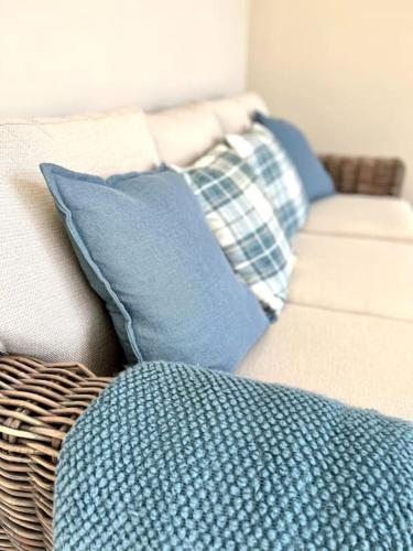 a group of pillows on a couch at Vast, Elegant Home with Indoor Pool & Sauna near Popular Golf Course in Kington
