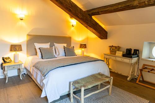 a bedroom with a large bed and two night stands at Maison Bournissac in Noves