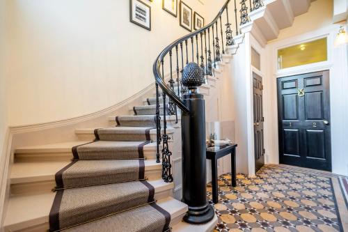a staircase in a home with a black door at 2 Rowntree House in York