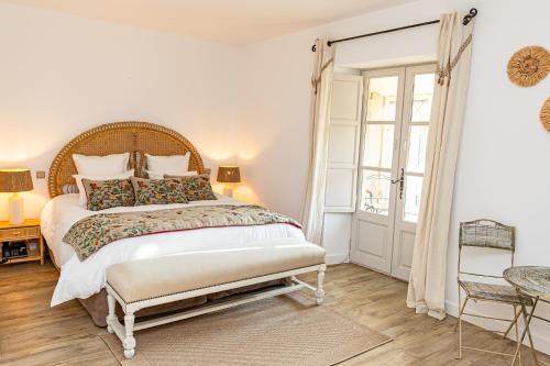 a bedroom with a large bed and a table at Maison Bournissac in Noves