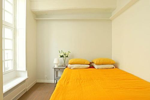 une chambre avec un lit avec deux oreillers dessus dans l'établissement Luxurious Apartment in Le Marais, à Paris