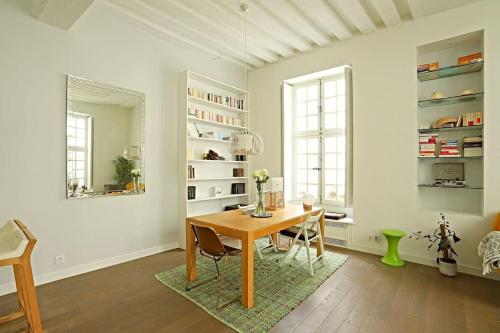 une salle à manger avec une table et des chaises dans une pièce dans l'établissement Luxurious Apartment in Le Marais, à Paris