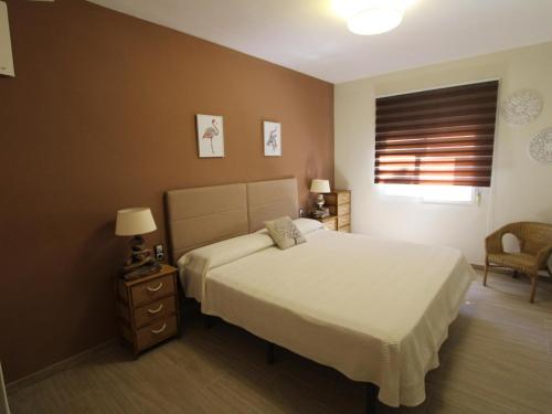 a bedroom with a white bed and a window at Casa cerca del mar con piscina privada, aire opcional, wifi gratuito, mascotas y playas para perros - ES-184-60 in L'Ametlla de Mar