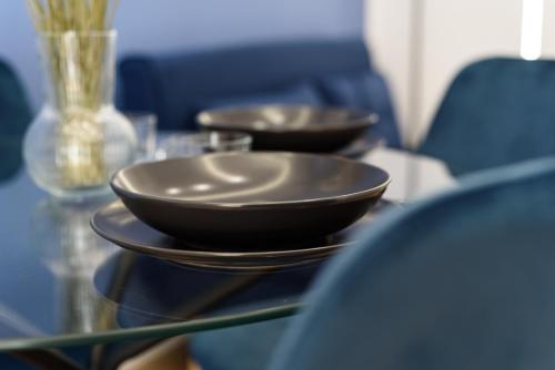 two bowls are sitting on a glass table at APPARTAMENTI VALLETTI ERCOLANO in Ercolano