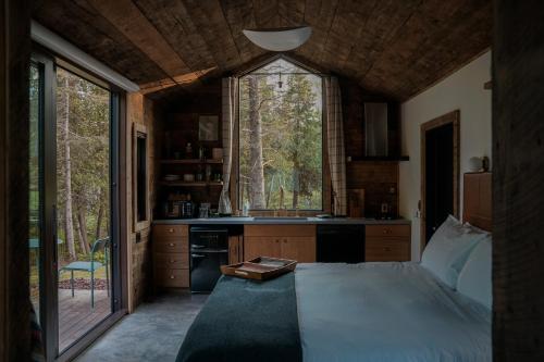 a bedroom with a bed and a large window at Tofte Trails in Tofte
