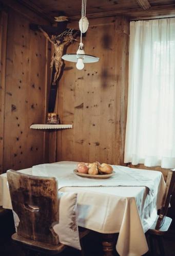 a table with a plate of bread on it at Ferienwohnung Burgfrieden Brixen with BrixenCard in Brixen