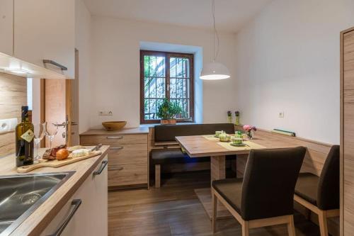 a kitchen and dining room with a table and chairs at Ferienwohnung Burgfrieden Brixen with BrixenCard in Brixen