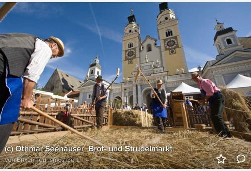 a group of people standing in front of a church at Ferienwohnung Burgfrieden Brixen with BrixenCard in Brixen