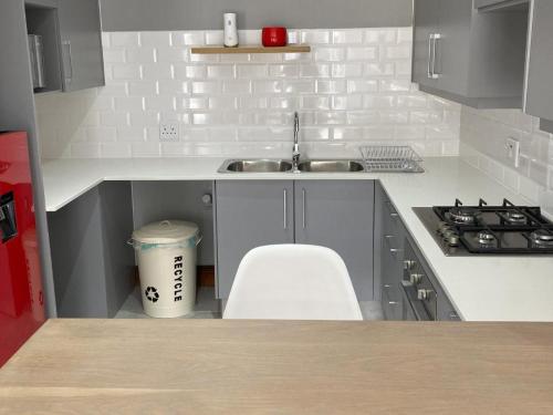 a small kitchen with a sink and a stove at StaySure Guesthouse in Alberton