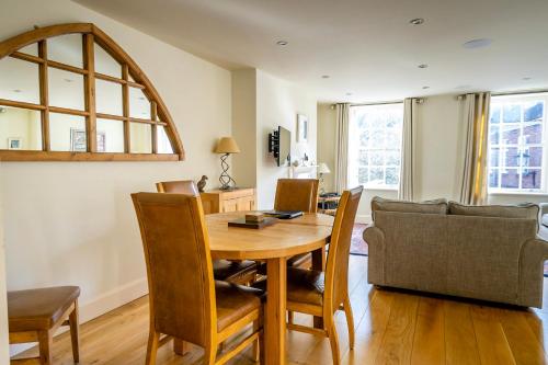 a dining room with a table and a couch at The Brierley in York