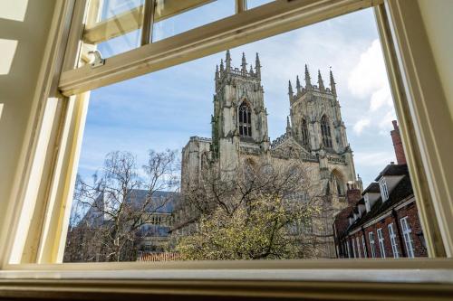 a window view of a cathedral from a building at The Brierley in York