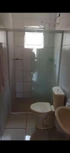 La salle de bains est pourvue de toilettes et d'un lavabo. dans l'établissement Casa Relax, à Caraguatatuba