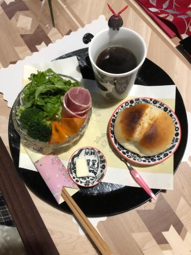 a table with a plate of food and a cup of coffee at 棚田ハウス in Murai