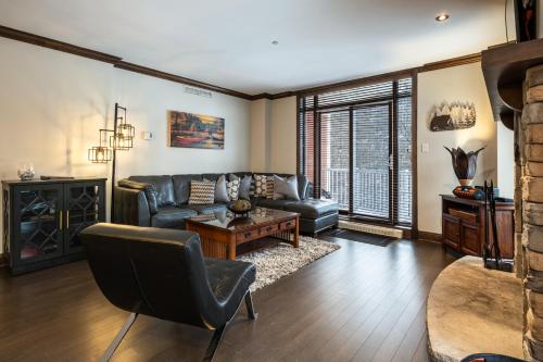 a living room with a couch and a table at Tremblant Prestige - BONDURANT 95-10 in Mont-Tremblant