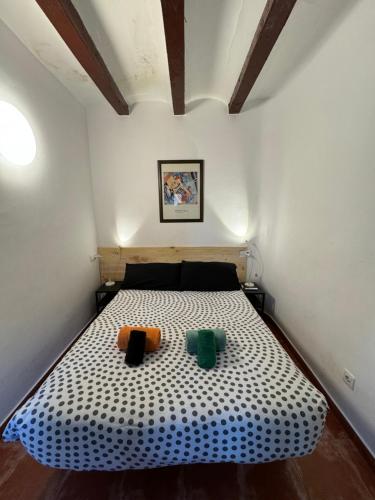 a bedroom with a bed with two pillows on it at Louie Louie Apartment Old Town in Tarragona