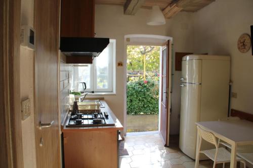 a kitchen with a stove and a refrigerator at Il Gelsomino in Trieste