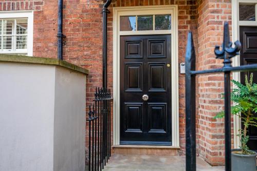 a black front door of a brick house at The Brierley in York