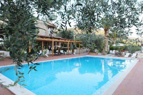 a large blue swimming pool with a gazebo at Le Cese in San Giovanni Rotondo