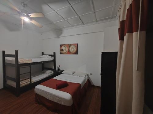 a bedroom with two bunk beds in a room at Hotel Casa Colon in San José