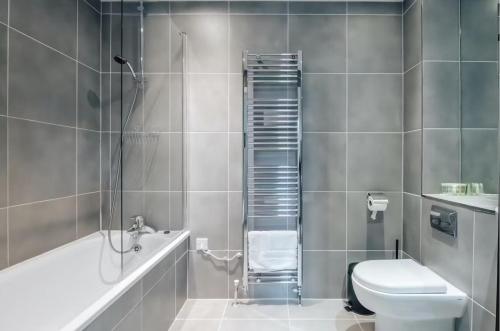 a bathroom with a shower and a toilet and a sink at Notting Hill 2-Bed Apt with Balcony 1 min to Tube in London