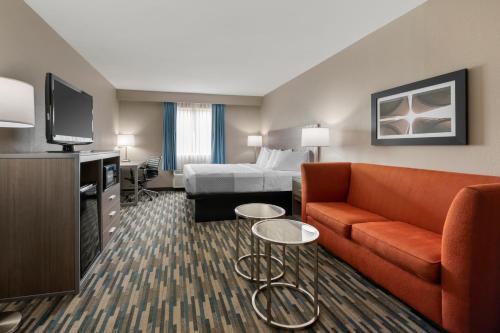 a hotel room with a couch and a bed at Best Western Edinburgh/Columbus in Edinburgh