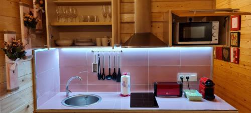 a kitchen counter with a sink and a microwave at Villa Maribel in Busot