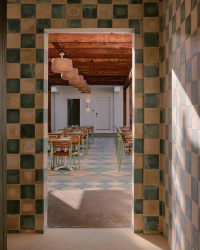 a view of a room with tables and chairs at Hotel Lucine in Galveston