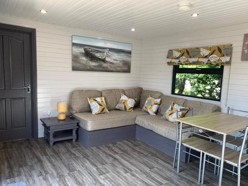 a living room with a couch and a table at Donegal Staycations in Clonmany