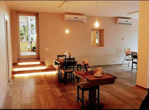 a living room with wooden floors and a dining room at B&B Verdeoliva in Modugno