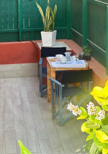 a small table and chair on a patio with plants at Boutique Apartments Ibiscus in Santa Maria