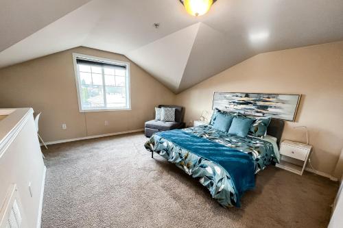 a attic bedroom with a bed and a window at City Sojourn in Seattle