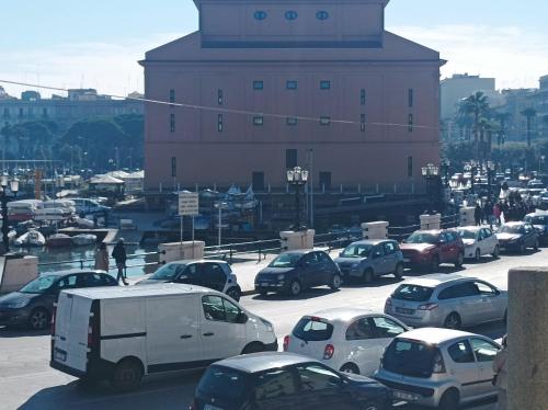 a parking lot filled with lots of cars and a building at Il sottano borgo antico in Bari