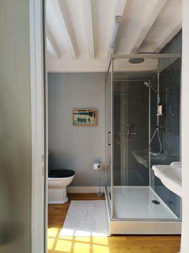 a bathroom with a glass shower and a toilet at La Thérèsienne in Pleines-Oeuvres