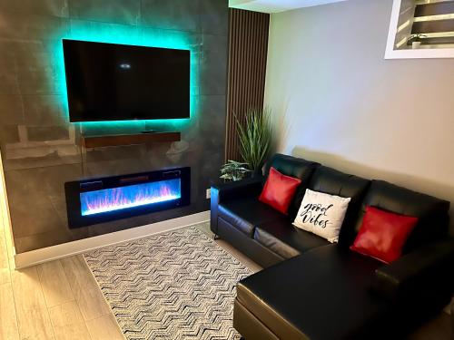 a living room with a couch and a fire place at Niagara Getaway across Fallsview in Niagara Falls