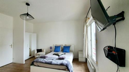 1 dormitorio con 1 cama y TV de pantalla plana en Les hauteurs au pied de la gare - Proximité Paris et Orly, en Villeneuve-Saint-Georges