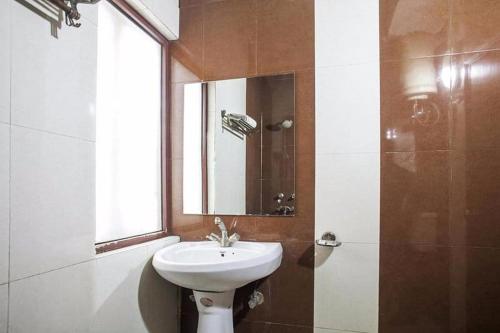 a bathroom with a sink and a mirror at Hotel Luxury Stay Near Us embassy Delhi in New Delhi