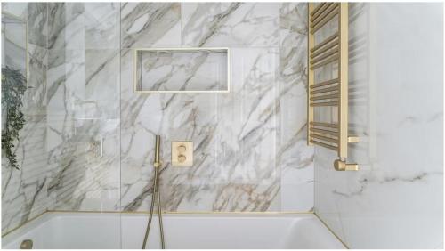 a bathroom with a white marble wall at 2-4 bedroom 2 roof terraces prime Notting Hill in London