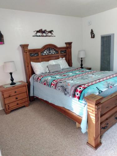 a bedroom with a bed and two night stands at Mokee Motel in Bluff