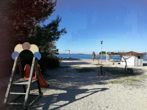 a playground with a slide and a swing at HOUSE Kod dide in Primošten